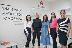 Five happy Female Milacron employees standing in our Brazil office in Campinas