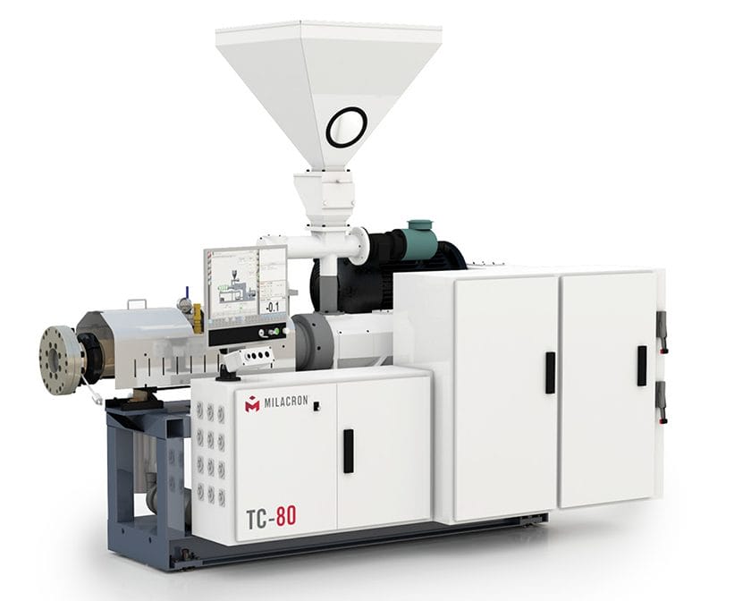 Angled view of Milacron's twin conical screw plastic extrusion machine.